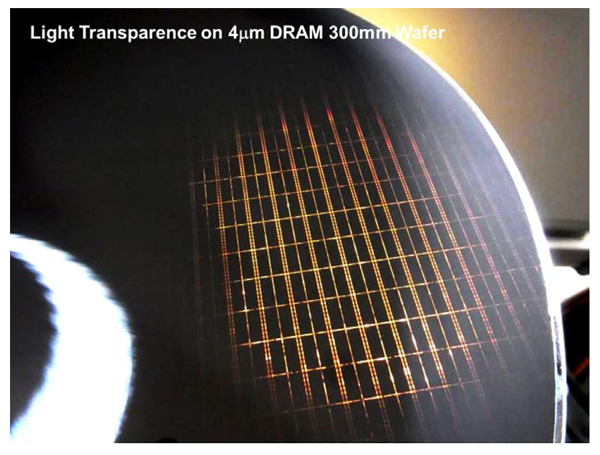 A 300mm DRAM wafer thinned-down to 4µm. When wafers become this thin visible light permeates them.