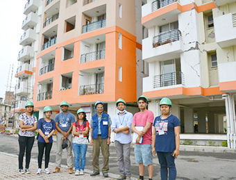 Field survey team at high-rise apartment building in Lalitpur with significant non-structural damage