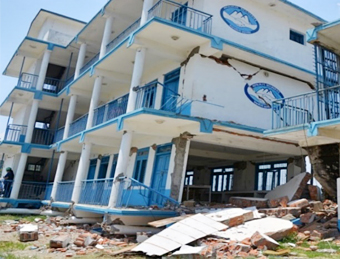 Collapsed four-story school building in Sangachowk, Sindhupalchowk district, with first-story columns at ground level
