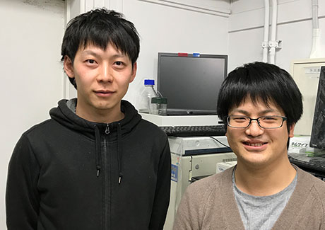 Lead author and Assistant Professor Fumitaka Ishiwari(left) and former master's student Gen Okabe in front of the high-performance liquid chromatography