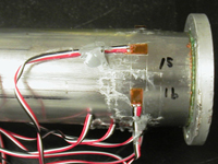 A bulge near the closed-end bottom created by reflection of the stress wave.