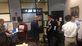 Workshop participants debating during a poster session