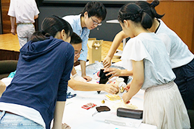 Team disassembling a metronome