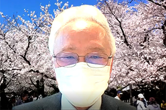 EVP Mizumoto in front of virtual cherry blossoms