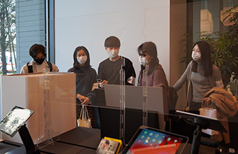 Student team checking out their prototype on display