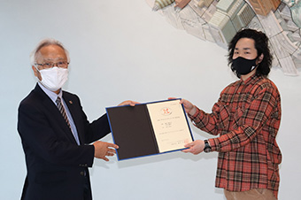 Shinoda (right) receiving certificate