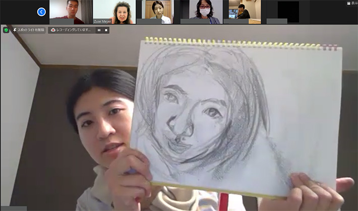 Student receiving Mayer's feedback on her self-portrait