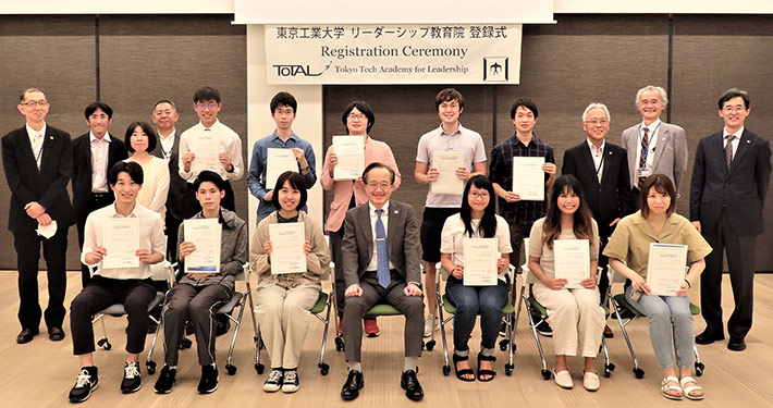 New students of June 2021 cohort, President Masu (front center), and faculty at live registration ceremony at Taki Plaza