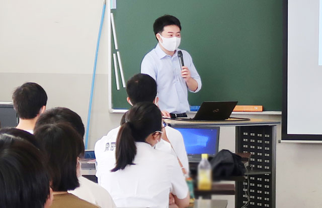 Doctoral student describing his research