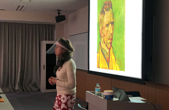 Meyer lecturing with van Gogh's portrait in background