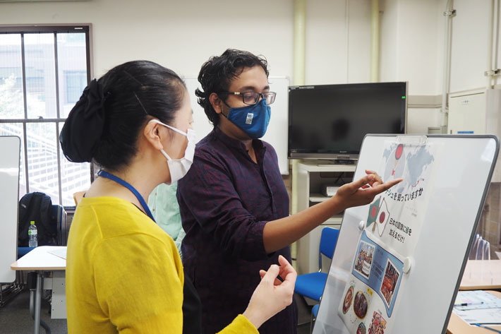 Student (right) presenting with help of poster