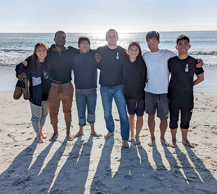 Yokoyama (2nd from right) with friends on beach in Monterey
