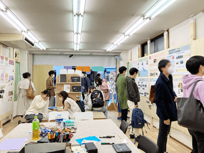 Visitors viewing exhibits and joining survey on what they like about Ookayama