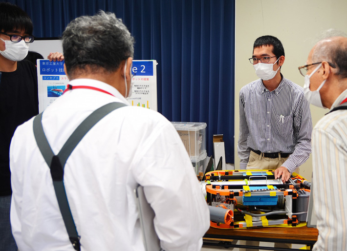 Aqua Lab members presenting their robot on land