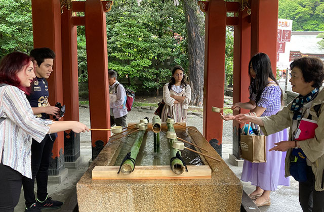 Students learning traditional hand-watering etiquette