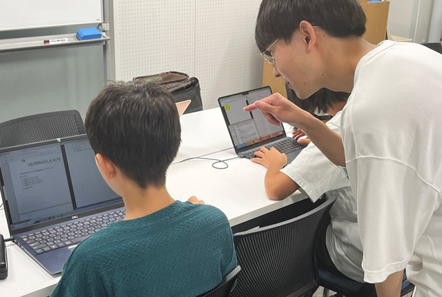traP member supporting coding class participants