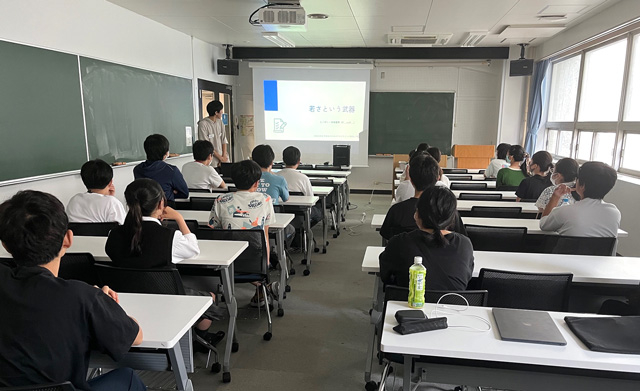 Participants listening intently to lightning talk