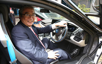 Tokyo Tech President Mishima testing an electric BMW car at NTU