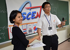 Project leader Lee (right) shaking hands with a participant