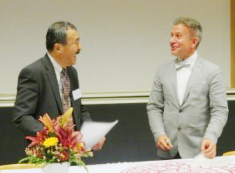 Executive Vice President Ando (left) and Vice-Rector Tysk (right) exchange copies of the joint inter-school agreement