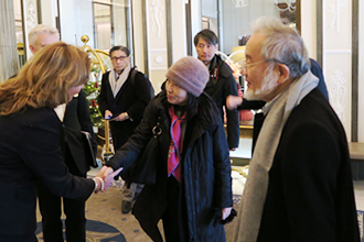 Ohsumi (right) and his wife (center) upon arrival at hotel