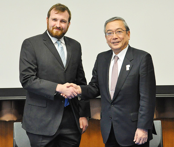 Charles Hoskinson (left), and Yoshinao Mishima (right), signed the agreement.