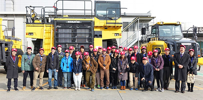 In front of super-sized dump truck at Komatsu's Ibaraki plant