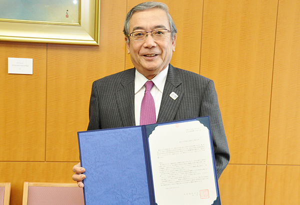 President Mishima with the certificate