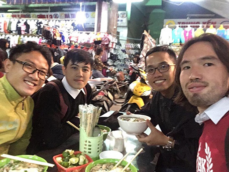 Enjoying Vietnamese noodle soup at night market