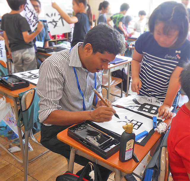 Viraj trying Japanese calligraphy