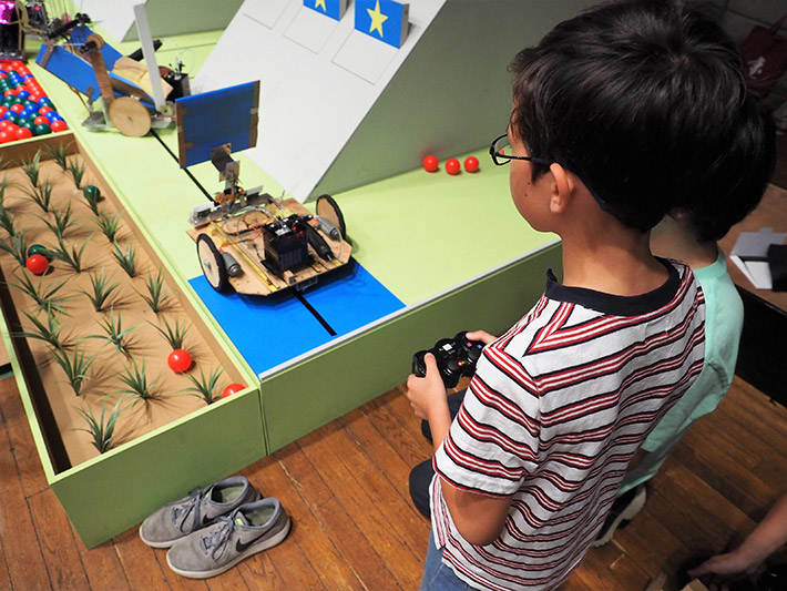 Elementary school students testing out robots