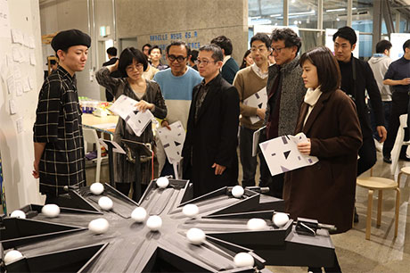 TUA's Shun Onozawa (far left) introducing his piece Movement Act as Toyama, Fujii and others look on