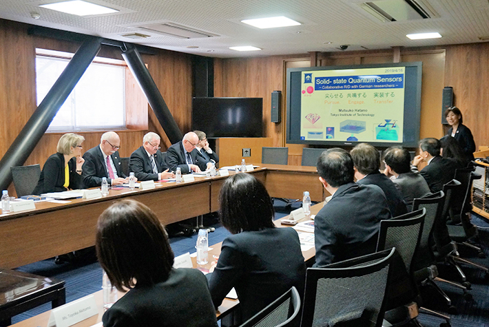 Professor Hatano (far right) briefs her research in solid-state quantum sensors