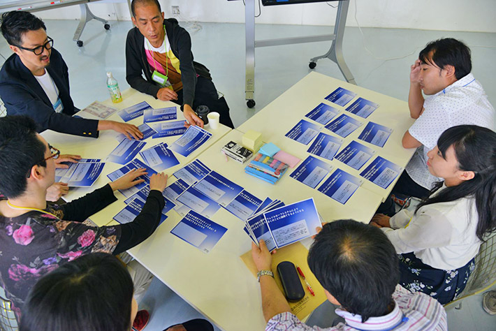 Team viewing and discussing "elements of the future" cards