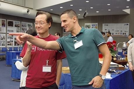 Masu (left) talking with attendee