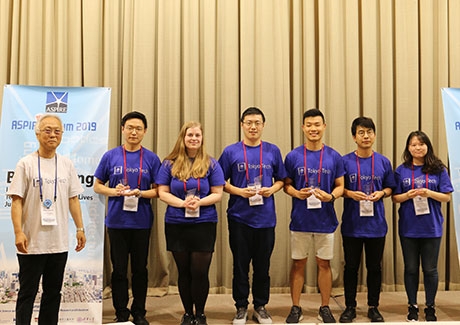 Okawa (second from right) and group members display Best Group Presentation awards