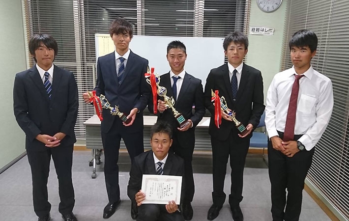 Sailing team captain Horie (back, center) with winning team