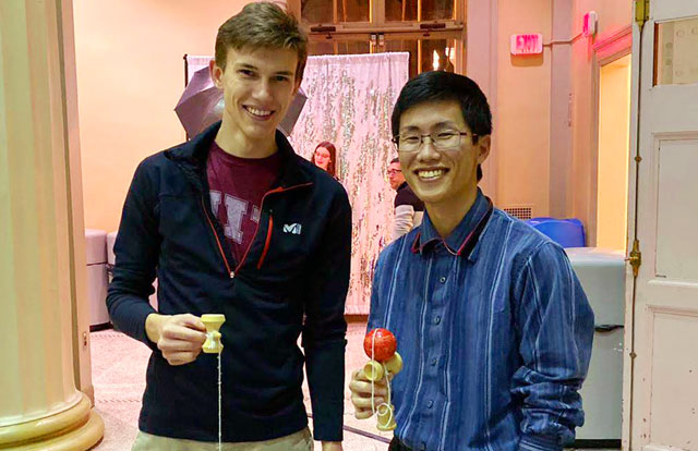 Sato (right) playing with kendama toy at Japanese Association of MIT (JAM) event