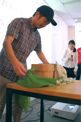 Audience member opening cardboard lunch boxes