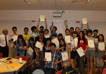 Students proudly holding their ASPIRE League Educational Certificates