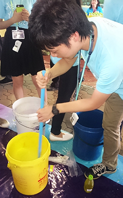 Visiting Thailand: Kataoka at Chao Phraya River (left) and demonstrating how to make organic washing liquid