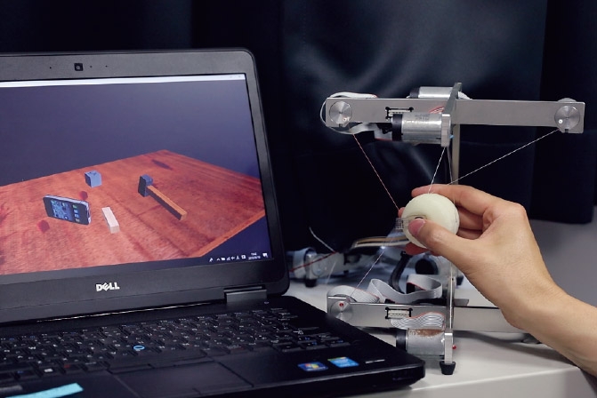 By grasping and moving a force sensor, it is possible to operate two points in VR space to grab an object. Hasegawa was the first to conduct research on presenting that sense of reaction force.