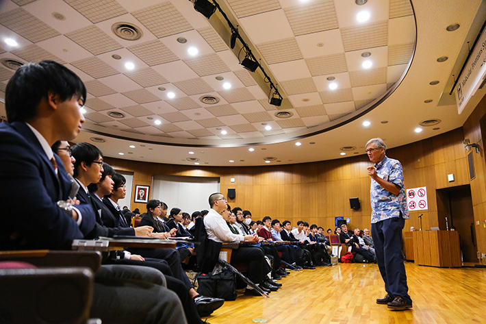 Dr. Hunt speaking with high school students