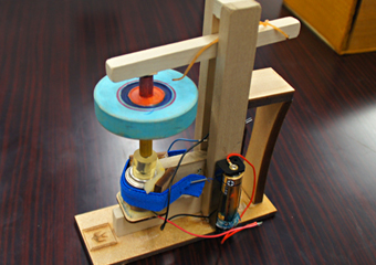 Power top with a motor to spin the top