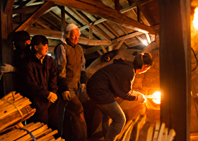 Adding firewood through smaller stoke holes located on the sides of the chambers