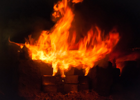 Flames rising from the kiln's chimney