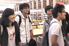 Hokuto Kato (center) in a library at MIT