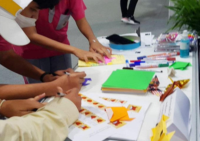 Participants making origami cows