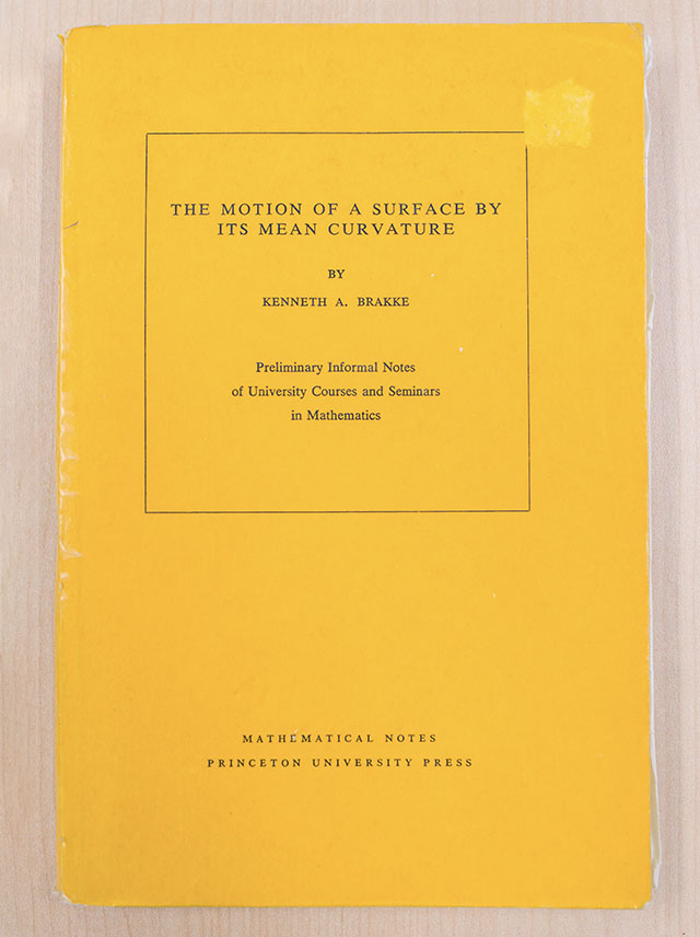 The Motion of a Surface by Its Mean Curvature, published by Brakke in 1978. Although it contained innovative ideas about mean curvature flow using geometric measure theory, it did not lead to the establishment of a mathematical theory.