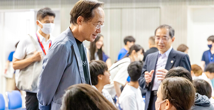 The two university presidents engaging in a conversation with the participants